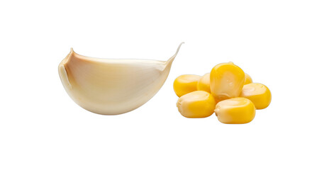 A single clove of garlic and a small pile of corn kernels isolated on transparent background