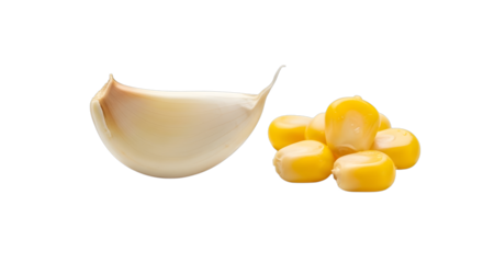 A single clove of garlic and a small pile of corn kernels isolated on transparent background