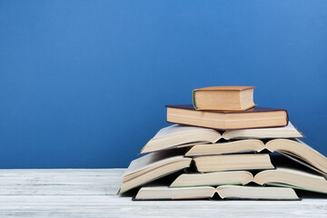 Open book, hardback colorful books on wooden table. Back to school. Copy space for text. Education business concept. © lana_u