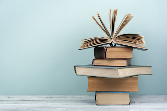 Stack of colorful books. Education background. Back to school. Book, hardback colorful books on wooden table. Education business concept. Copy space for text.