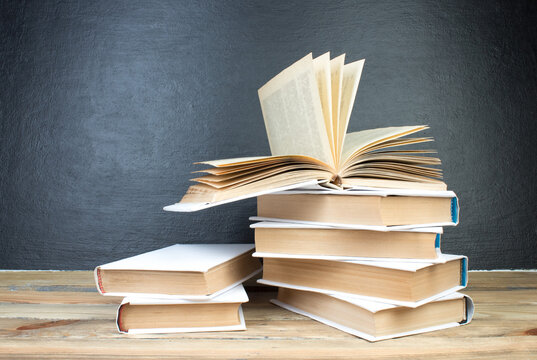 open book, books on the background school board. Back to school. Education. Copy space for text.