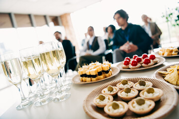 Business gathering featuring diverse team members enjoying refreshments during a collaborative meeting session