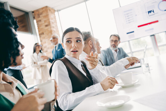Business team engaged in discussion during a professional meeting at a modern office with collaborative atmosphere