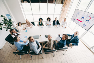 Professional team during a dynamic business meeting showcasing collaboration, leadership, and teamwork in a modern office setting