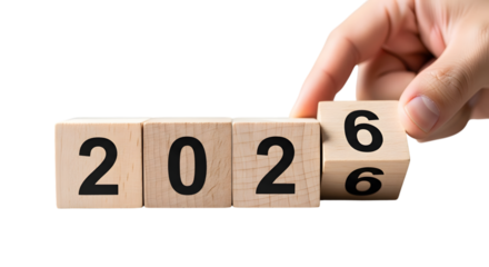 Hand turning wooden blocks from 2026 to 2027 on black background