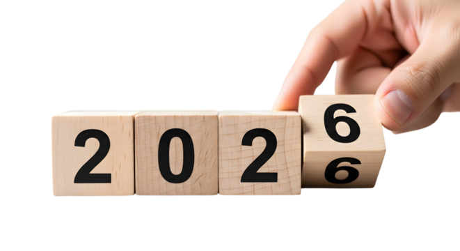 Hand turning wooden blocks from 2026 to 2027 on black background