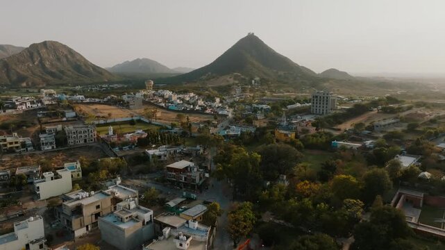 Aerial view of Pushkar, where buildings contrast with the rugged mountains, creating a blend of urban and natural landscapes, Pushkar, Rajasthan, india.