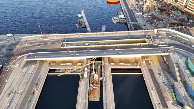 Aerial view of a construction site at Vattentorget with water pools, cranes, and roads, creating a stark contrast between industry and nature, Stockholm, Stockholms lan, Sweden.
