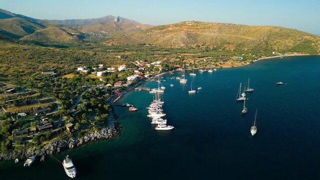Aerial view of boats resting on the sea near the beach, with mountains in the background, Cokertme, Mugla, Turkiye.