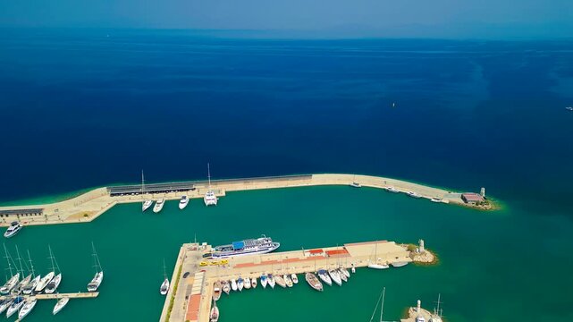 Aerial view of Kormen Marina, where yachts rest in turquoise waters against the backdrop of the deep blue sea, Datca, Mugla, Turkey.