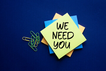 We need you symbol. Concept words We need you on sticky. Beautiful deep blue background. Business...