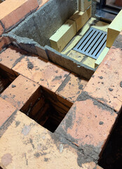 Formation of a fireclay core for a solid fuel furnace. Cast iron grate has been installed. Construction of a heating furnace.