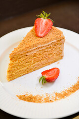 Slice of layered honey cake Russian Medovik. Delicious homemade dessert.