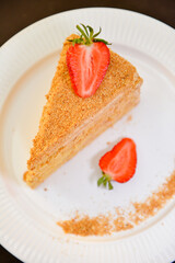 Slice of layered honey cake Russian Medovik. Delicious homemade dessert.