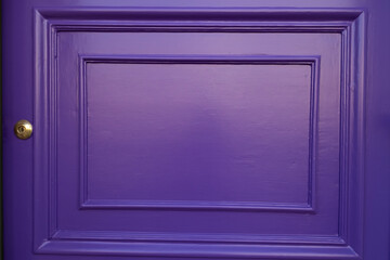 Close up of a traditional purple wooden front door, at a house in Morningside, Edinburgh, Scotland, UK