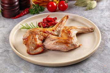 Roasted rabbit leg served rosemary