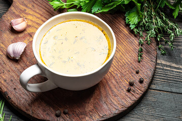 Beef bone broth with herbs in mug