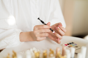 Apply smear Pat Glue to fingernails