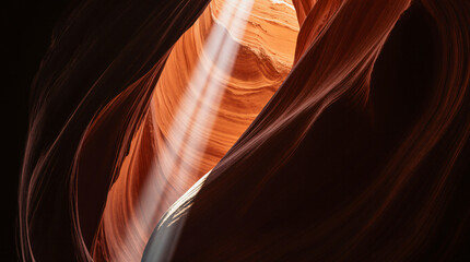 Obraz premium Interior of a dramatic crevice in a sandstone canyon with a vertical beam of sunlight.