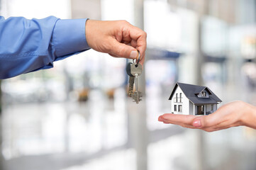 Exciting moment of handing over house keys after a successful real estate purchase