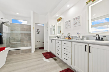 A bathroom with a bathtub, sinks, mirrors, and a shower