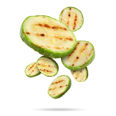 Grilled pieces of zucchini falling on white background