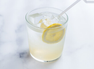 Glass of lemonade. This cool drink is perfect for hot days, offering a delightful blend of sweet and sour flavors to quench your thirst.