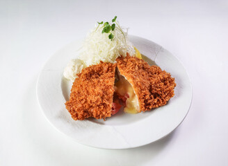 Crispy fried cutlet filled with cheese and tomato, served with fresh cabbage salad. Perfect for menus, recipes