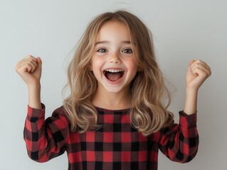 Little Girl's Expression of Pure Joy Shines Through as She Celebrates on a Plain Background