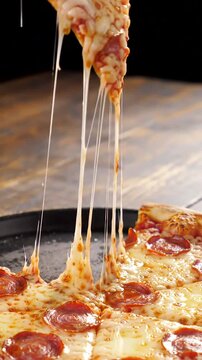 Melting cheese and pepperoni on a slice of pizza, perfect for any food lover's craving.
