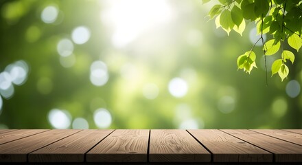 Wooden table top with blurred green nature background and sunlight