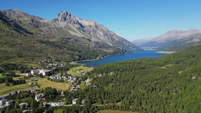 Aerial view of the alpine lake Sils in Switzerland. Beautiful landscape of nature, mountain peaks and forests, travel in Europe.