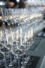 Many champagne glasses in a luxurious ambiance. Stylish, slightly dark-toned photograph....