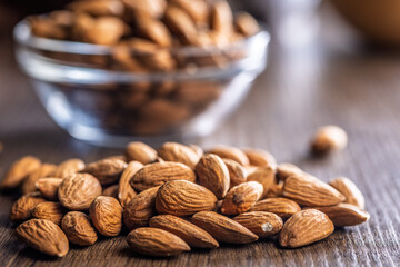 Almond kernel nuts on wooden table.