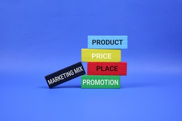 A stack of colored wooden blocks labeled Product, Price, Place, and Promotion sits against an blue backdrop, representing the marketing mix concept and promotional strategy in business.