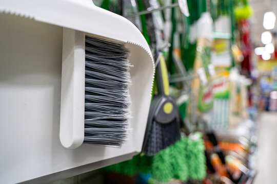 Close up of cleaning brushes hanging in store aisle.