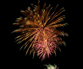 Fireworks explosions against black night sky