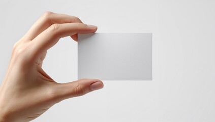 Fototapeta premium Human Hand Holding a Blank Business Card mockup Isolated on White