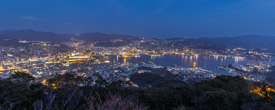 Impressive panoramic view durinblue hour in the evening from the observation deck at the summit of Mount Inasa in Nagasaki in Japan
