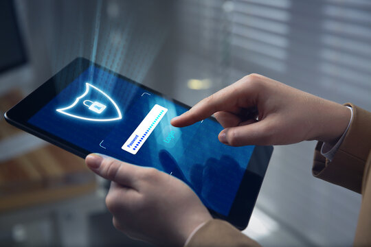 Cyber security and data protection concept. Woman using tablet computer, closeup. Password box, shield with lock and button Login on device screen