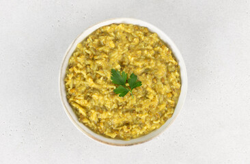 Traditional Indian khichdi (kichari) with rice, lentils, spices on a white background. Ayurvedic detox food concept.
