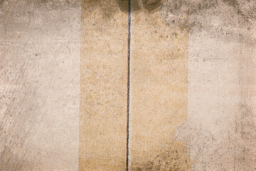 The top of the cardboard has adhesive tape on it and there are dirt stains.