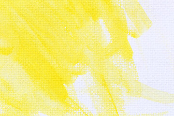 Yellow watercolour paint brush on the white art paper background.