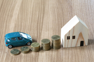 Car and House Investment Concept with Coins