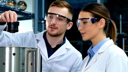 Young Male and Female Scientists Collaborating in Laboratory Experimentation