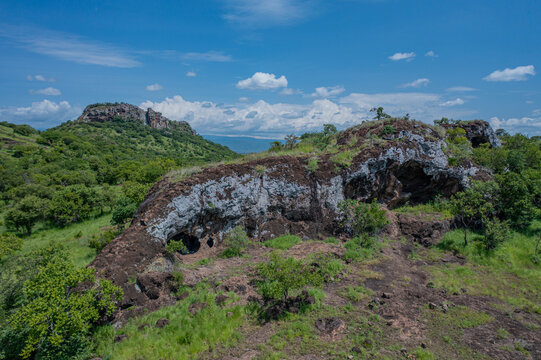 Aerial view of the Napedet cave under a vast sky, creating a striking contrast of textures and tones, Pian Upe Game Reserve, Moroto, Uganda.