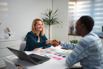 Businesswomen shaking hands after successful meeting