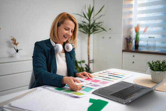 Woman designer working on color palette in home office