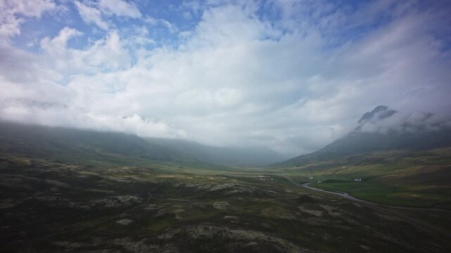 Aerial flyover of wide glacial valley / Akureyri, Iceland