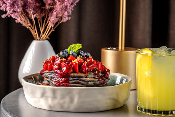 berry pancakes with blueberry and strawberry topping